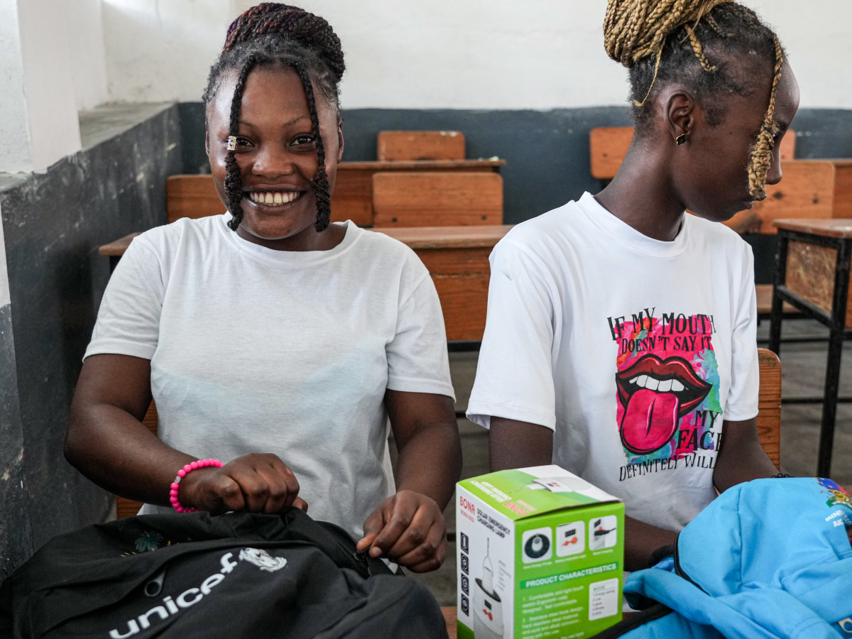 Schülerinnen mit Rucksäcken im Klassenzimmer in Haiti.