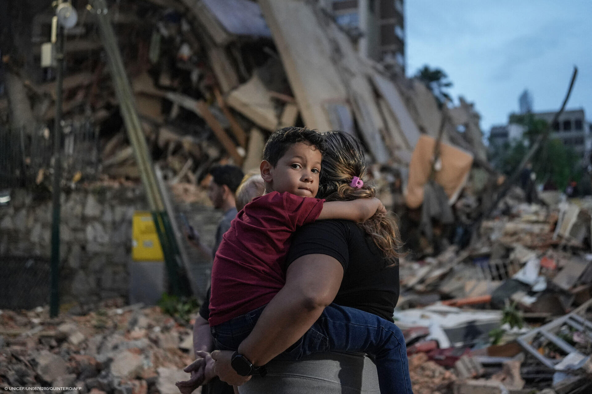 Menschen gehen an einem eingestürzten Gebäude vorbei, das nach einem Erdbeben am 25. Juni 2026 in Caracas eingestürzt ist.